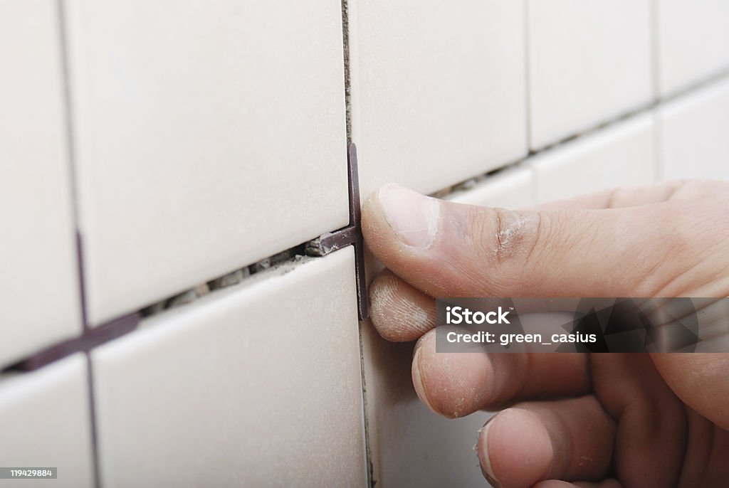 Man installing ceramic tile  Grout Stock Photo