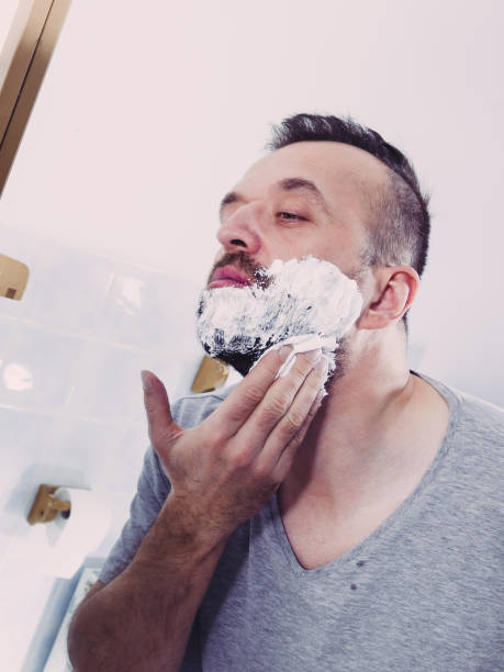 istock Man applying shaving cream on beard 1194299498