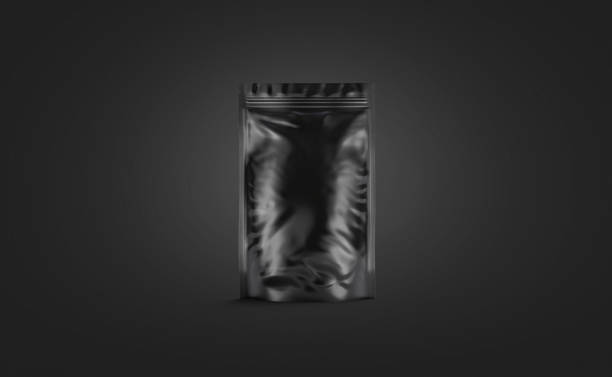 istock Blank black plastick pouch mockup stand isolated on darkness background 1194299529