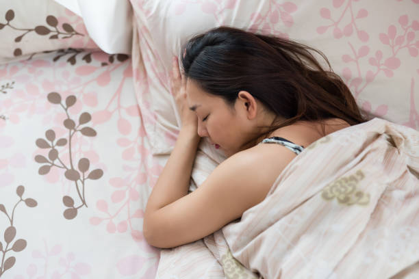 istock Asian woman sleep on bed 1194301612