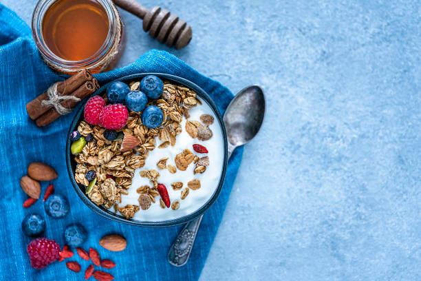 istock Healthy food: homemade yogurt and granola shot from above on blue table. Copy space 1194301775