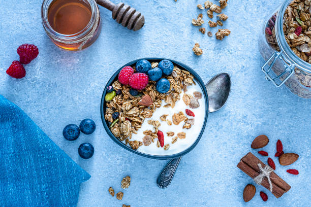 istock Healthy food: homemade yogurt and granola shot from above on blue table. Copy space 1194301959