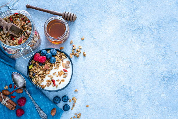 istock Healthy food: homemade yogurt and granola shot from above on blue table. Copy space 1194302090