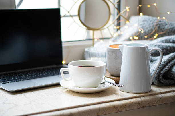 Cozy freelancer's winter work place at home with cup of coffee