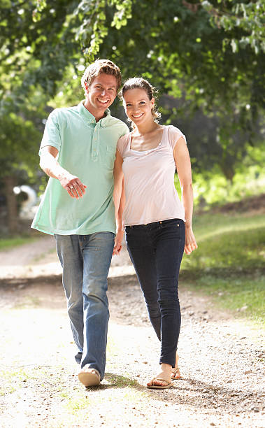 istock Affectionate Couple Walking In Countryside Together 119430382