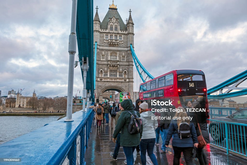 London Tower Bridge London, UK - Dec 11, 2019: Commuters crossing Tower Bridge during rush hour. Tower Bridge links the South of River Thames to the City area. Tower Bridge Stock Photo