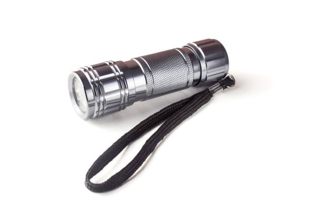 istock metal LED flashlight with a black cord on a white isolated background 1194304555