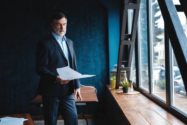 istock Confident pensive mature business man in modern office. 1194304718