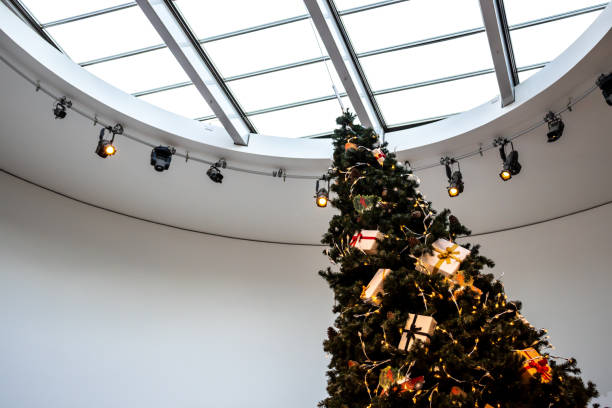 istock Christmas tree in front of simple white background with down lighting 1194304992