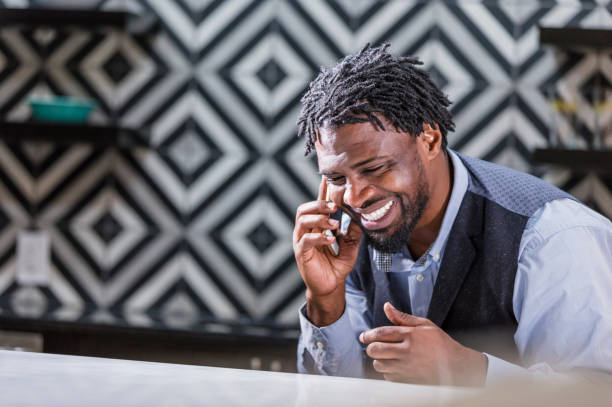 istock African-American man with short dreadlocks on phone 1194306495