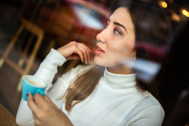 istock Female Asian drinking coffee in a coffeehouse 1194306632