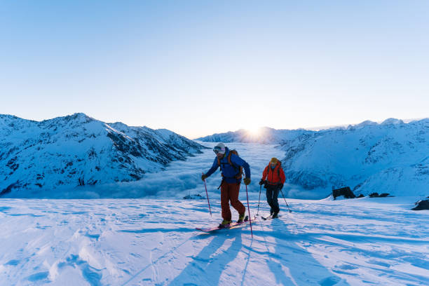 istock Backcountry skiers ascend snowy ridge 1194308082