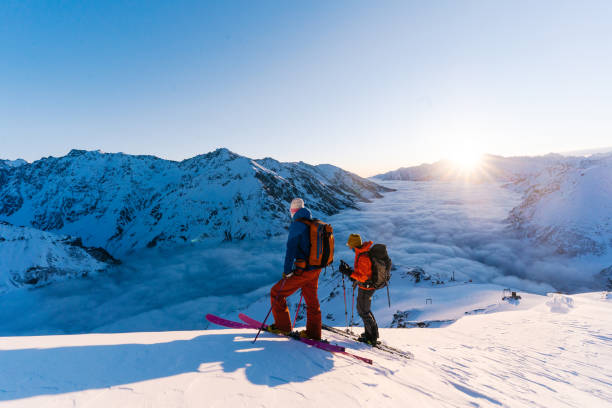 istock Backcountry skiers ascend snowy ridge 1194308098