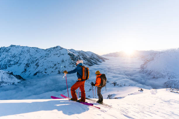 istock Backcountry skiers ascend snowy ridge 1194308118