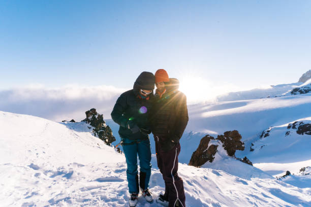 istock Mountaineers use cell phone on snowy ridge 1194308133