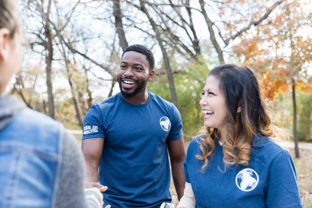 istock Mid adult man greets volunteer during community event 1194308397