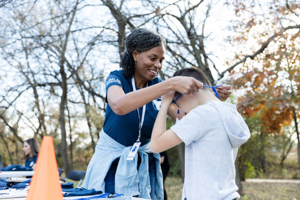 istock Elementary age boy volunteers during community cleanup event 1194308410