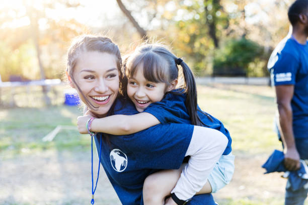 istock Happy sisters enjoy volunteering together 1194308425