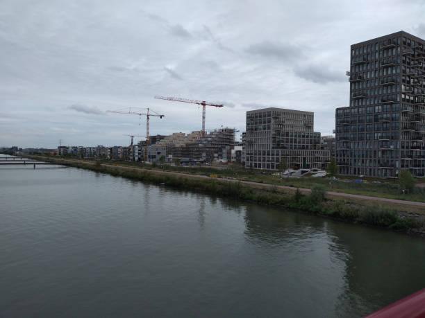 istock a tower block with cranes near the water 1194309713