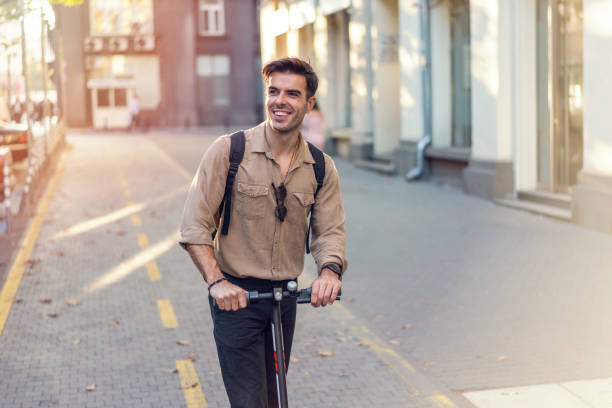 istock Man riding e-scooter on the street 1194310187