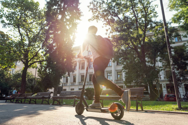 istock Student riding e-scooter through the city 1194310216
