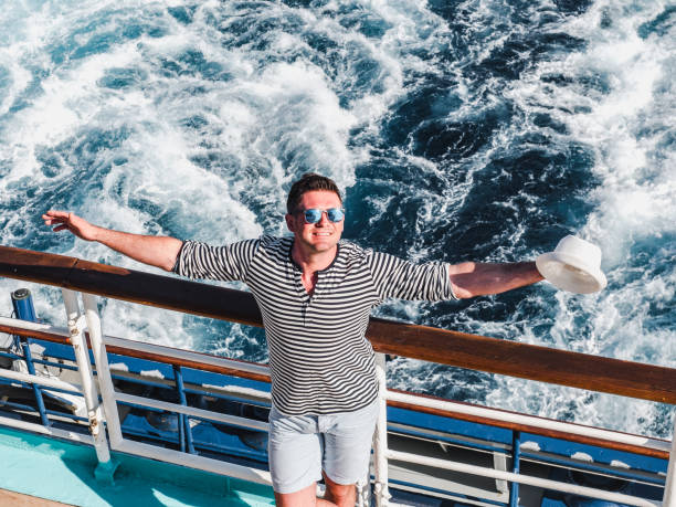istock Smiling man on the empty deck of a liner 1194311548