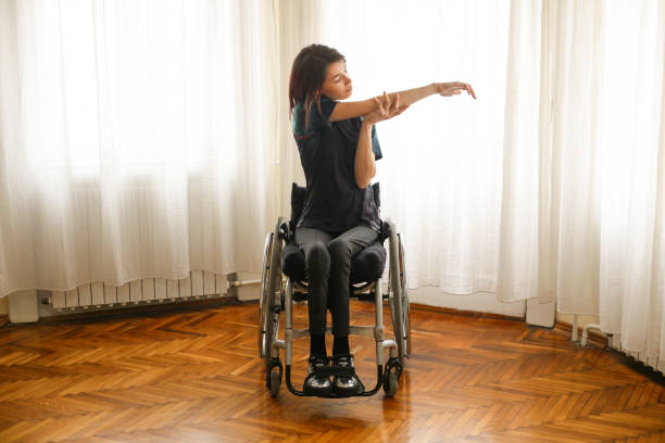 istock Disabled woman exercising at home 1194311616