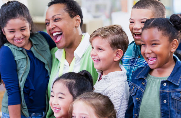 istock Teacher and elementary school students in classroom 1194311750