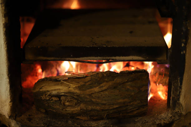 Fire in a furnace closeup. Flames of fire in a wood burning stove. Red tongues of fire in a rustic stove