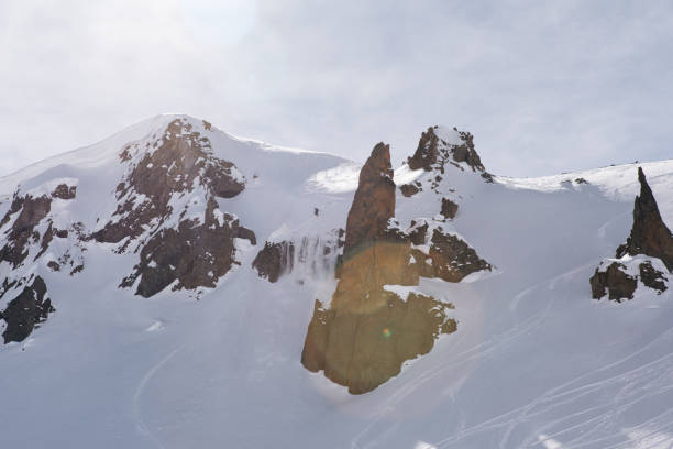 istock Distant backcountry skier descends snowy ridge 1194313053