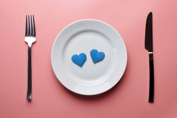 istock Two blue hearts in plate. Romantic dating. Dinner without discrimination against sexual minorities. LGBT wedding banquet preparation. 1194315295