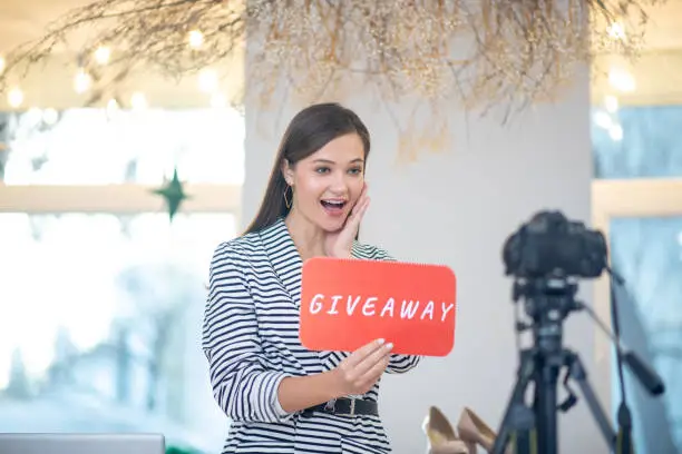 Photo of Positive emotional woman having a giveaway on her blog