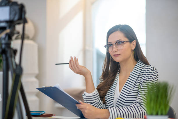 istock Smart young woman sitting with her notes 1194317199