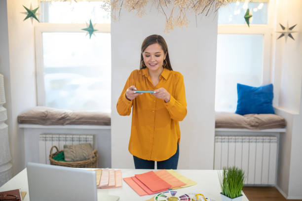 istock Attractive young woman standing at the desk 1194317241