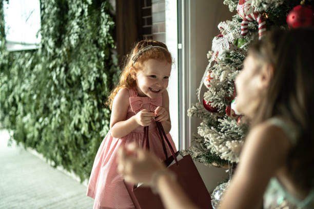 Sister receiving Christmas present at home Sister receiving Christmas present at home happy birthday cousin images stock pictures, royalty-free photos & images