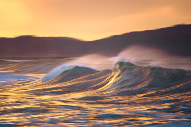 istock Photo of a big wave breaking at sunset with in camera panning technique 1194318565