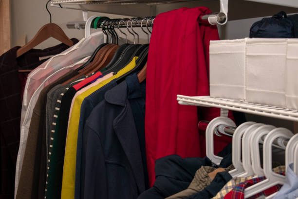 istock Rail with multi-colored clothes on hangers and in containers. Open storage system. horizontal photo 1194319276