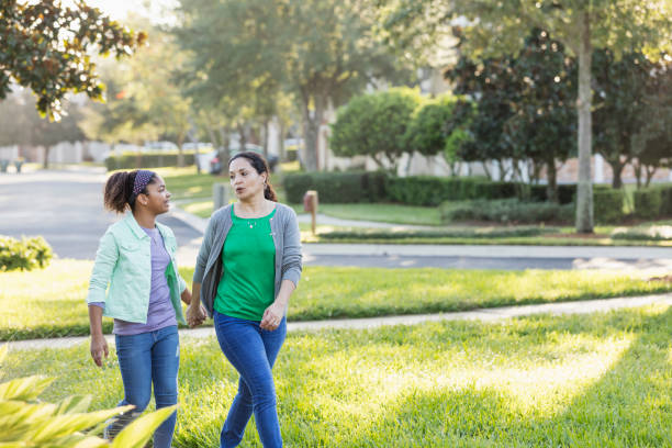 istock Mother and daughter taking a walk, holding hands 1194319738
