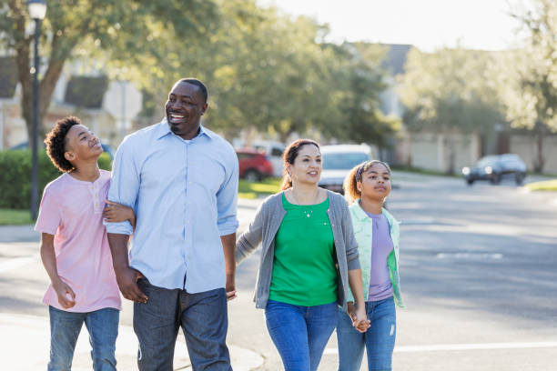 istock Interracial family, two children, taking walk together 1194319872