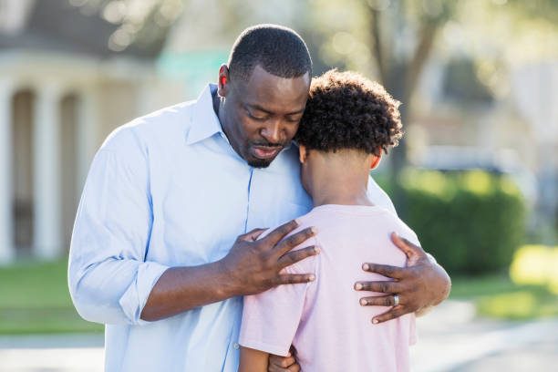 istock Father consoling his teenage son 1194320034
