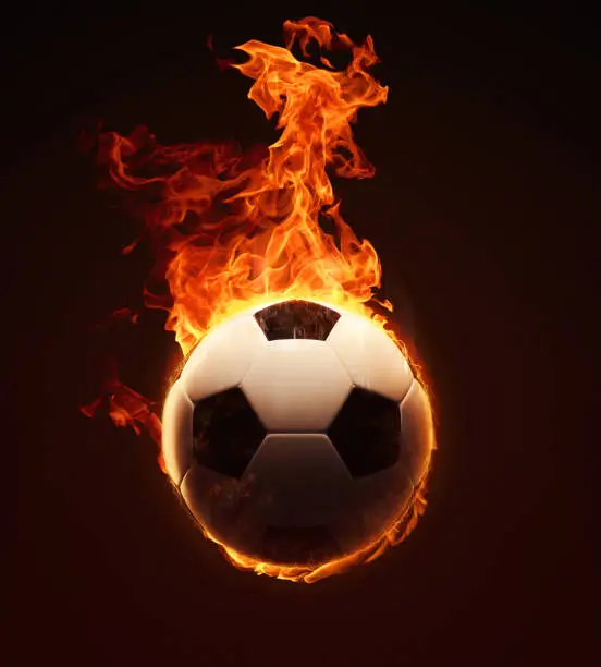 Burning fiery soccer ball among flames