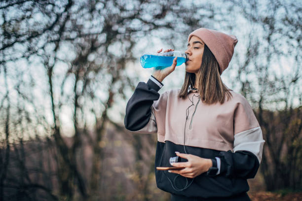 istock Young woman is drinking energy drink 1194321149