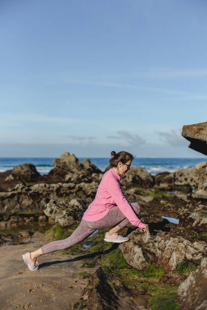 istock Brunette woman practicing yoga on the beach 1194322024