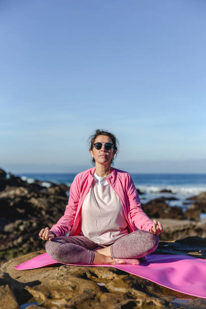 istock Brunette woman practicing yoga on the beach 1194322026