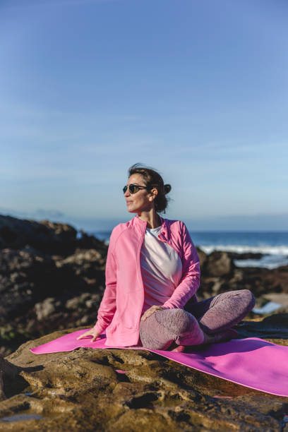 istock Brunette woman practicing yoga on the beach 1194322091