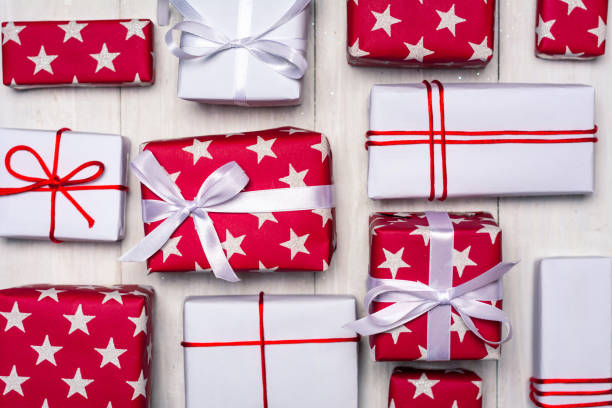 istock Christmas presents on a wooden table top view 1194325589