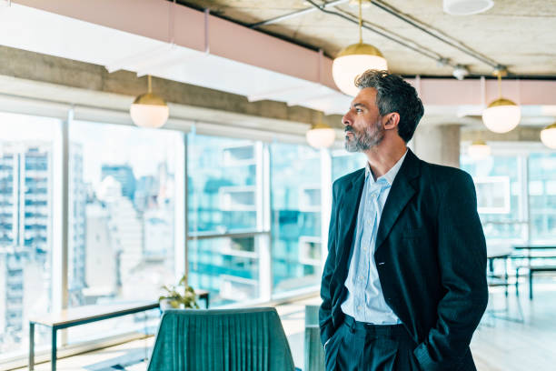 istock Businessman looking at the view from his office 1194326315