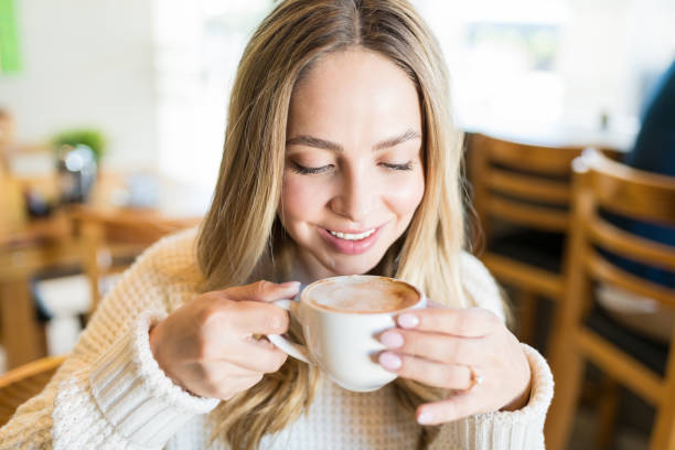istock Beautiful Female Having Drink At Cafe 1194327589