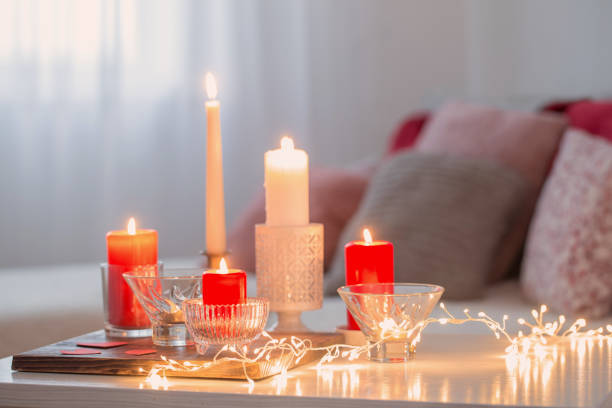 istock Burning candles on white table in interior. Valentines day concept 1194327706