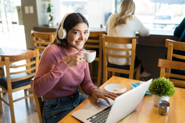 istock Portrait Of Blogger Drinking Coffee While Working On Laptop At Cafe 1194330143
